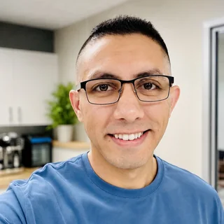 Sam Khalaf, smiling, wearing glasses and a blue T-shirt.
